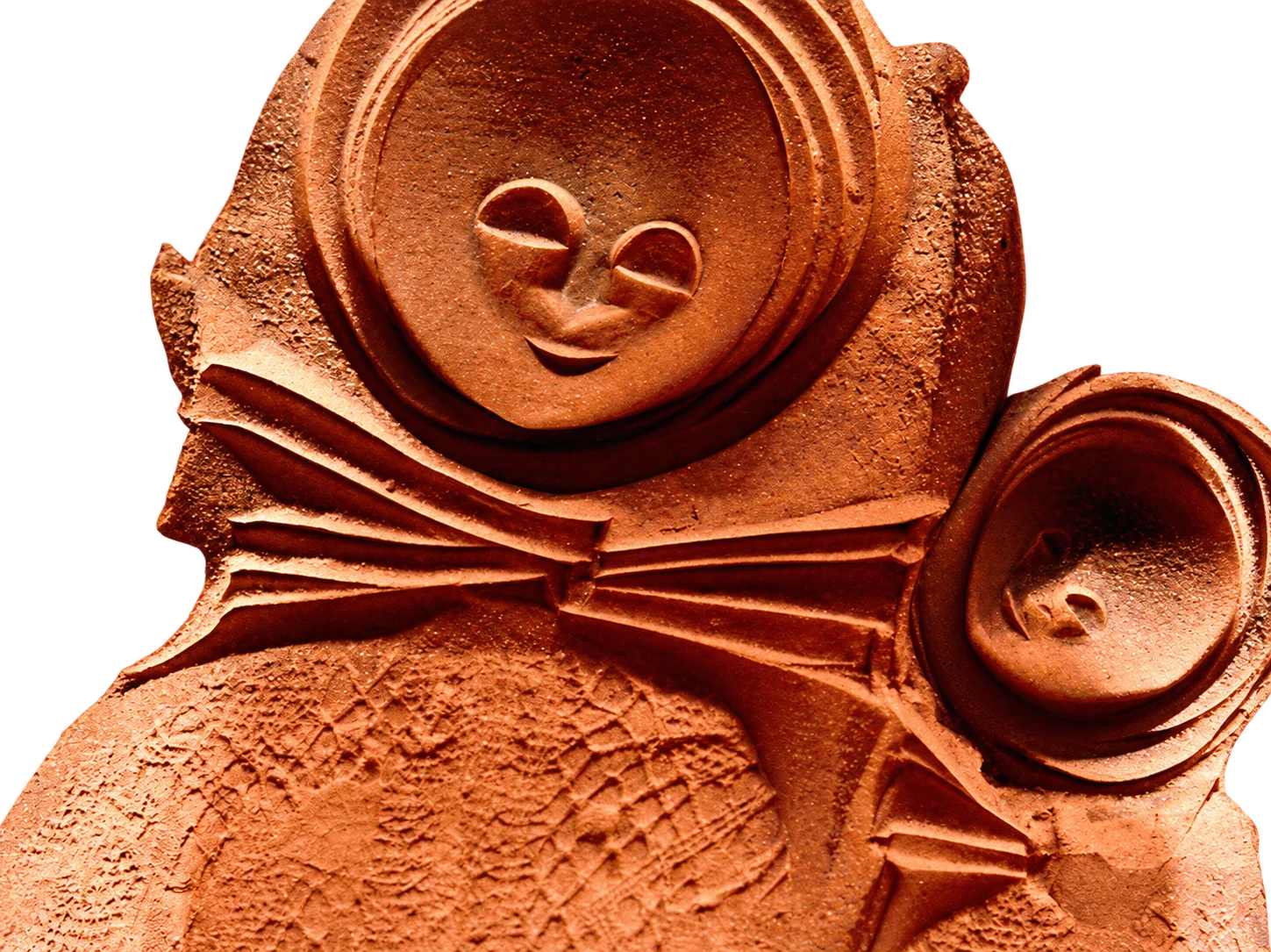 Gros plan sur une sculpture en terre cuite orangée représentant un visage souriant aux yeux fermés, un nœud papillon plissé et un second petit visage sur la droite.